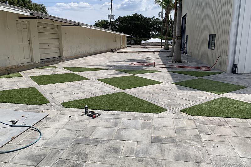 Turf diamonds set into a large-format paver surface